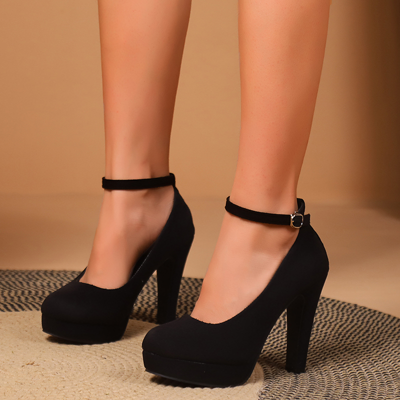Women's black platform high heels with ankle straps and closed toes